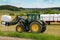 Farmer Stacks up Silage with Front Loader John Deere 6330 Tractor