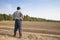 Farmer standing on farming land