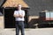 Farmer Standing In Front Of Farm Buildings