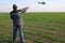 A farmer standing on his wheat field points at a small airplane.