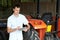 Farmer Standing Next To Tractor Using Digital Tablet