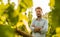 Farmer standing proud in front of a vineyard - agriculture