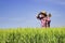 Farmer standing in wheat field and looking across