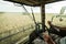 Farmer at steering wheel of Ñombine harvester on a wheat field