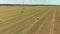 The farmer stores up feed for livestock. Tractor picks up the mown dry hay with a roll wrapper