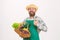 Farmer straw hat hold eggplant and basket vegetables. Fresh organic vegetables wicker basket. Man bearded presenting