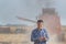 Farmer with tablet in front of combine harvester in soybean field