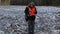 Farmer with tablet PC on frozen field in winter