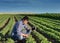 Farmer with tablet in soybean field