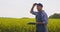 Farmer taking notes at rapeseed field