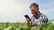 Farmer taking pictures of soybean plantation. Brazilian Farm. Quality control. Agronomist's work