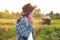 Farmer talking on the purple phone on the tractor background. Amidst the vast expanse of a field, a farmer confidently