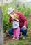 Farmer teaching child how to grow grapes