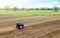 A farmer on a tractor cultivates a farm field. Field preparation for new crop planting. Cultivation equipment. Grinding and