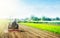 A farmer on a tractor cultivates a field before a new planting. Soil milling, crumbling and mixing. Loosening the surface,