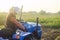 A farmer on a tractor drives across the farm field. Agricultural management skills and earthworks. Potato harvest campaign.