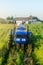 A farmer on a tractor drives across the farm field and harvests. Farming, agriculture. Improving agricultural practices using