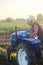 A farmer on a tractor drives across the farm field. Potato harvest campaign. Farming, agriculture. Harvesting potatoes in autumn.