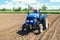 Farmer on a tractor loosens the soil with milling equipment. Loosening surface, land cultivation. Farming, agriculture. Plowing