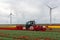 Farmer at tractor with mechanical device cutting blossoms tulip flowers