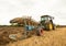 Farmer in a tractor ploughing a field in late summer. UK