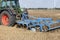 Farmer with tractor plows field in late summer on countryside of lower saxony in germany