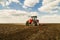 Farmer in tractor preparing land with seedbed cultivator