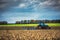 Farmer in tractor preparing land with seedbed cultivator