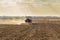 Farmer in tractor preparing land with seedbed cultivator as part of pre seeding activities in early spring season of agricultural