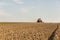 Farmer in tractor preparing land with seedbed cultivator as part of pre seeding activities in early spring season of agricultural