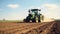 Farmer in tractor preparing land with seedbed cultivator as part of pre seeding activities in early spring season of agricultural