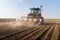 Farmer with tractor seeding - sowing soy crops at agricultural f