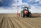 Farmer in tractor sowing crops