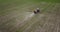 Farmer on a tractor with a sprayer makes fertilizer