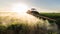 Farmer on a tractor with a sprayer makes fertilizer for young vegetable