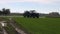 Farmer tractor spraying crop field