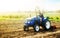 A farmer on a tractor works on the field. Cultivation technology equipment. Growing crops in a small agricultural family