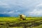 Farmer uses machine to harvest rice on paddy field.