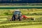 Farmer using a Fendt tractor for work after mowing grass