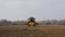 Farmer using a self propelled crop sprayer in a field in early spring.