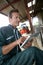 Farmer using tablet in barn