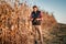 Farmer using tablet on the crop fields, managing harvester and organising