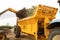 Farmer using a telehandler to load manure into a muck spreader.