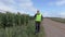 Farmer on walkie talkie at the edge of cornfield