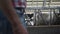 Farmer walking modern cowshed between cows rows close up. Worker inspecting .