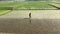 Farmer walking through the paddy land to soften the soil