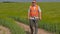 Farmer walking and using tablet PC at cereals field