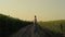 Farmer watching sunflower field in evening sunlight. Agrarian rest country road