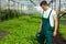 Farmer watering basil plants