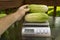 Farmer Weighing Produce For Customer